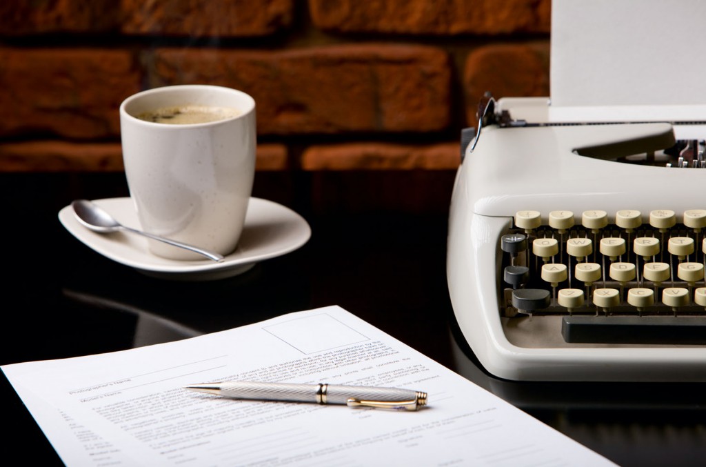 Once upon a time... Old fashioned morning scene: antique typewriter, cup of fresh coffee, business contract and pen